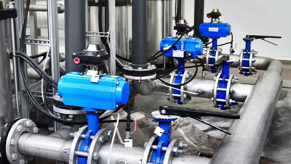 Steel metal pipes with blue pumps and valves