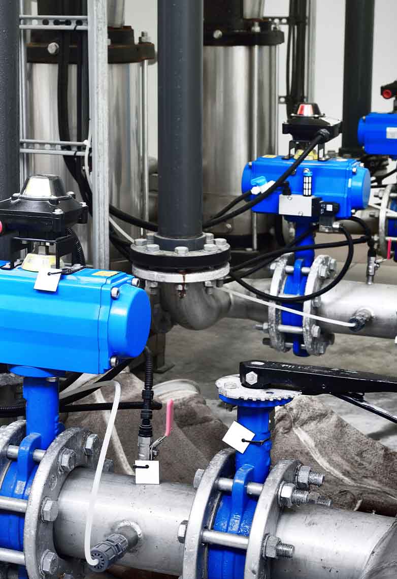 Steel metal pipes with blue pumps and valves